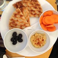 hummus plate with pita crunchy bread and olives  at cacao in Prague