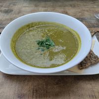 Spinach soup with half a slice of bread at GustaV in Salzburg