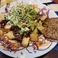 Salad with smoked cashew cheese, gluten-free bread, sprouts, pumpkin seeds, sunflower seeds, carrots, cabbage at GustaV in Salzburg