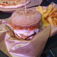 Burger with tempeh, fries, and vegan pizza at Green Bus in Wroclaw