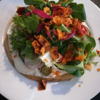 Chickpea omelet with mayonnaise, salad & coconut-based bacon on top at Cafe Michelle in Warsaw