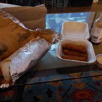 Giant burrito and mozzarella sticks. My bottle of tapatio. at Homegrown Smoker in Portland