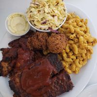 Platter with ribs, smoked chicken, coleslaw, Mac n cheese, and hush puppies at Homegrown Smoker in Portland