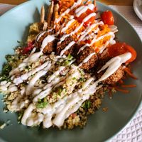 Couscous bowl with grated carrot and beet salad and falafel at Alcachofra Cafe in Faro