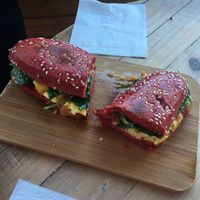 Avo, cheese n spinach toastie in beetroot bun at Love Your Soul in Parkdale