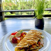 Avocado Omelet – a magical, plant-based, egg-free omelet filled with creamy avocado, baked sweet potatoes, and slices of fresh tomato. at Moksa in Ubud