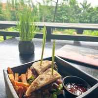 Triple Decker Sandwich with sweet potato fries -homemade coconut bread filled with lettuce, tomatoes, mushroom shawarma, avocado, and jack chik-un. at Moksa in Ubud