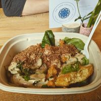 Mixed greens, sweets/turnips, grit cake, housemade pickles drizzled with tahini and topped with onion coconut. Simply delicious! at Kindly Kitchen in Boone