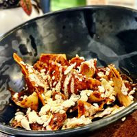 Chilaquiles de mole. Agrégales milanesa, deshebrada y más   at Vegan Ville in Mexico City