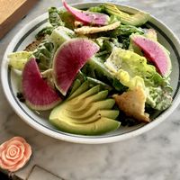 Little Gem Caesar salad with watermelon radish, avocado, and sourdough croutons at Kindred in San Diego