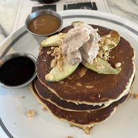 Pancakes: Bourbon Butterscotch & syrup on side, Caramelized Apple, Toasted Peanuts, & Whipped Coconut Cream  at Kindred in San Diego