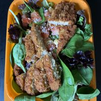 ‘Chicken’ Caesar Salad (power greens, garbanzo beans, diced tomatoes, Parmesan ’cheese’, and your choice of CRISPY or grilled ‘chicken’ strips) at Plant Power Fast Food - Ocean Beach in San Diego