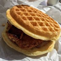 Chicken 'n' Waffle Sandwich with maple bacon syrup. Indulgent and delicious. at Plant Power Fast Food - Ocean Beach in San Diego