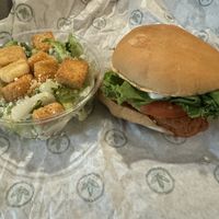 Chicken burger and side Caesar salad  at Plant Power Fast Food - Ocean Beach in San Diego
