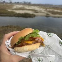 Bbq burger with onion rings and vegan bacon  at Plant Power Fast Food - Ocean Beach in San Diego