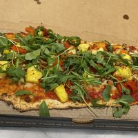 DIY pizza with Red sauce, Vegan cheese, vegan sausage, pineapple, jalapeño, roasted red peppers, and arugula.  at IAD - &pizza - CC in Dulles