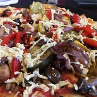 Roasted vegetable pizza with vegan pizzas sauce, mushrooms, kalamata olives, and vegan cheese. Delicious!!! at Blue Highway Pizza in Ocala