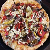 Roasted vegetable pizza with vegan pizzas sauce, mushrooms, kalamata olives, and vegan cheese. Delicious!!! at Blue Highway Pizza in Ocala