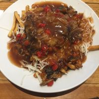 Poutine with vegan cheese, onion, mushroom, roasted red peppers and poutine gravy (2 vegan gravy choices) at Poutineville in Quebec