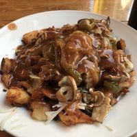 Crushed potatoes, vegan cheese, onions, mushrooms, jalapeños, 911 sauce at Poutineville in Quebec
