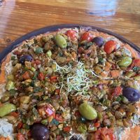 Pizza with buckwheat dough and veggies  at Curcuma in El Chalten
