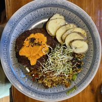 Aduki bean burger patties with carrot cream, rice, sautéed veggies and baked potato  at Curcuma in El Chalten