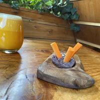 Orange, grapefruit, lemon and ginger juice along with appetiser (complimentary with meal) of carrots and bean dip. Yum!!   at Curcuma in El Chalten