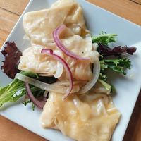 Creamy tender pierogies in butter sauce at Root in Lancaster
