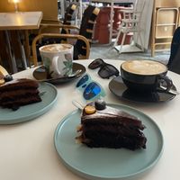 Chocolate cake, latte and chai latte  at Kohvik Must Puudel in Tallinn