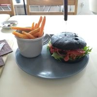 Vegan kebab burger (with pickled onion) and sweet potato fries at Kohvik Must Puudel in Tallinn