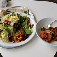 Green salad, carrots, pumpkin seeds, cranberries, pecans, hummus, tofu "egg" salad... eggplant curry, vegan tartare at Hiltl - Dachterrasse in Zurich