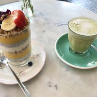 Vegan mango/lime ‘triffle’ layered with fruit, soya yogurt, chia pudding and cashew/coconut granola, topped with fruit and flowers. With matcha latte    at By Lima in Haarlem