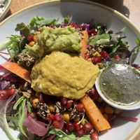 Eastern bowl: black rice, salad, carrots, curry chickpeas, mango hummus, avocado hummus, spiced seeds, cilantro topping  at By Lima in Haarlem