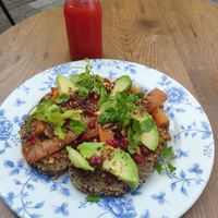 Muhammara bread with paprika, walnut, pomogranate, roasted cumin carrots and avocado. Also pictured is the slow juice with pineapple, watermelon and lemon crest at By Lima in Haarlem