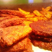 Vegan snacks - Lentil Fries/patties to the right, Seasoned potato wedges behind and Gluten slices to the left. Everything seasoned with natural herbs and spices and freshly made from scratch. at Roots Reggae Vegetarian Cafe in Bridgetown