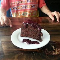 Chocolate cake with dark berry sauce 😋 at The Pitted Date in Playa Del Carmen