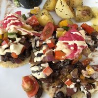 Huevos Rancheros w/black beans & Potatoes. Cut open so you can see the layers at The Pitted Date in Playa Del Carmen