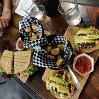 Bagelwich and lentil Patty sandwich with home fries at The Pitted Date in Playa Del Carmen