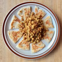 Pea Plata.
Steamed Soft Yellow pea with crunchy shallots and garlic sauce, pair with layer bread, it is crispy outside, chewy inside. at Yoma Burmese Restaurant in Allston