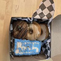 Birthday cake and three type of donuts at Erin McKenna's Bakery in New York City