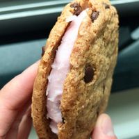 Chocolate chip cookie sandwich with (pink) vanilla frosting. at Erin McKenna's Bakery in New York City