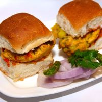 Vada Paav. A Mumbai street food made up of two parts; Vada - a mixture of Potato (boiled, mashed and tempered) coated with Chick pea flour and deep fried. Served in Dinner rolls with Garlic Chutney! at Saattveek in Auckland