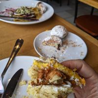 Almost forgot to snap a photo before it was gone. Breakfast sandwich in hand, beignets in background at Reverie Cafe + Bar in Minneapolis