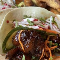 Korean BBQ Mock Duck tacos with a side of potato wedges.  at Reverie Cafe + Bar in Minneapolis
