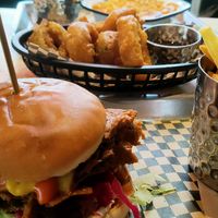 BBQ brisket burger, mac n cheese, and onion rings at Lucky Pig - Paradise Palms in Edinburgh