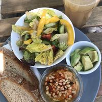 Ginger lemonade and vegan plate with side avocado. Ask for vegan dressing.  at Cafe DA in Stuttgart