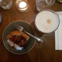 Pear/plum tart with soya whipped cream and an oat latte at Hoezo in Leiden