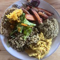 Roasted veg, bread with fermented veg, barley, yellow lentils, and a mashed green dish (?)  at Modir Jord in Egilsstadir