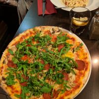 Pizza is spicy salami with mushroom, pepper and rocket. Vegan cheese too. Pasta is carbonara with ham bits at Feca in Stockholm