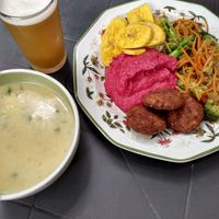 Peanut soup, juice drink, banana chips, pureed beets, grain croquettes, sauteed vegetables at Tulsi Plant Based in Envigado